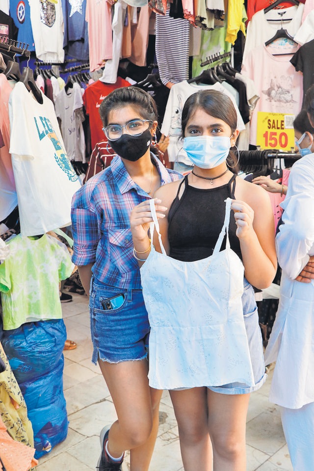 A shopper buys a cami top at a reasonable price from Sarojini Nagar market. (Photo: Dhruv Sethi/HT)