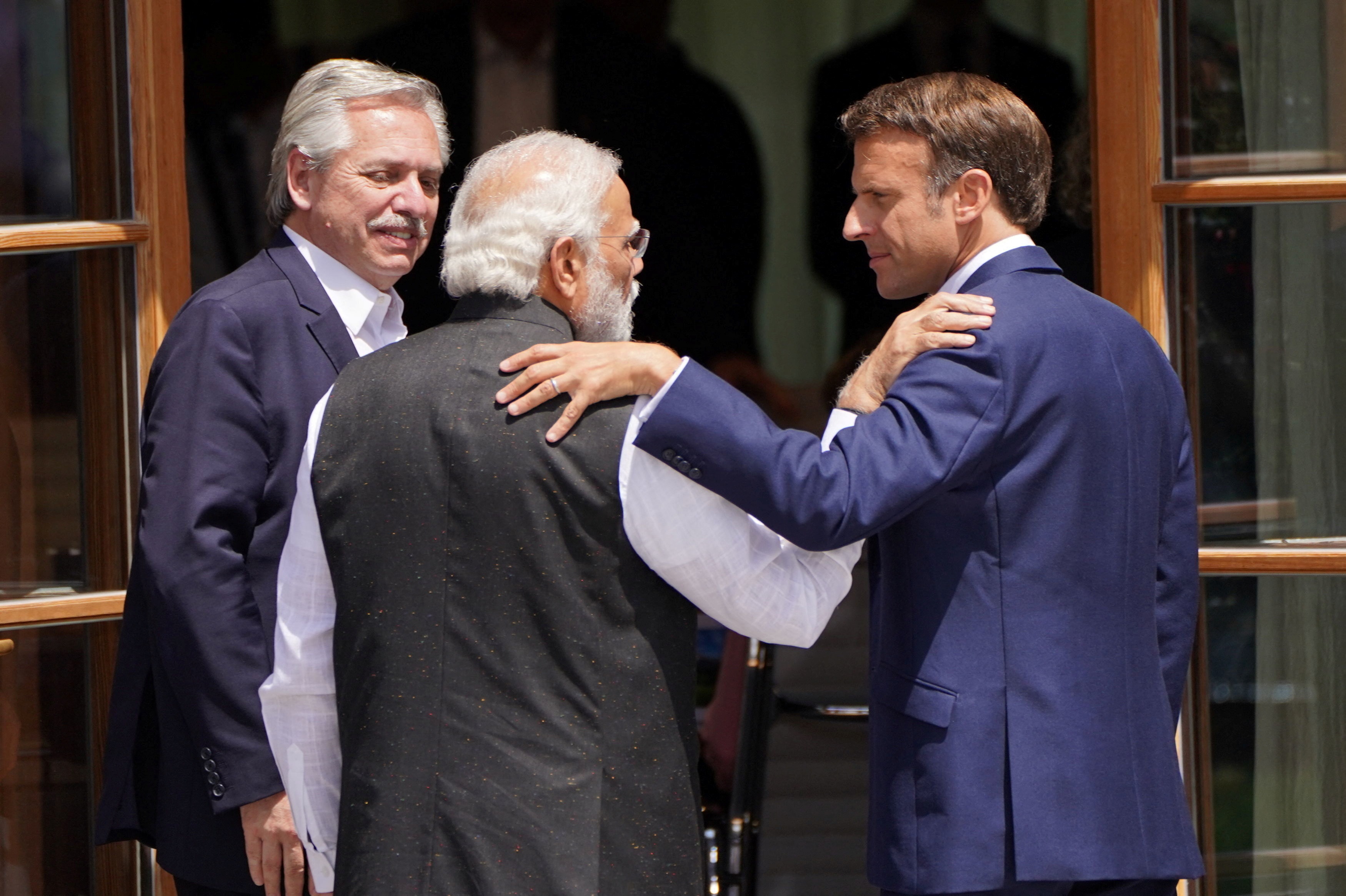 PM Modi and French President Emmanuel Macron talk after a group photo of leaders from the G7 and partner countries at the summit. (Reuters)