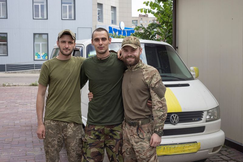 Anton (R), a soldier who returned from Sievierodonetsk, poses for a picture with his friend. (REUTERS)