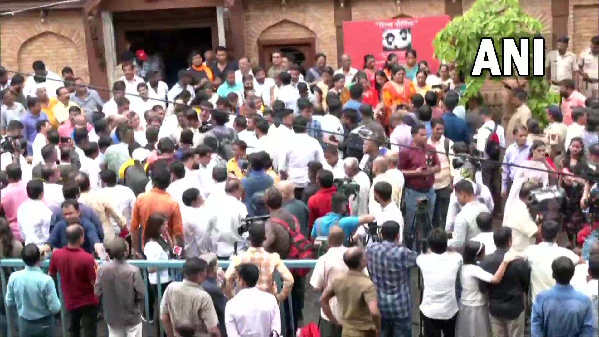Supporters of Eknath Shinde gather outside his residence in Thane. (ANI)