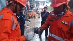 NDRF officials giving water to the rescued pigeon.