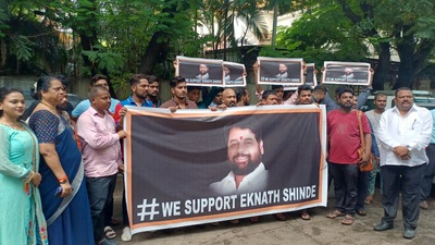 Supporters of Shiv Sena rebel Leader Eknath Shinde holds a banner reads "WE Support Eknath Shinde", in Thane on Wednesday. (Praful Gangurde)