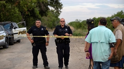 Law enforcement officers work at the scene where people were found dead inside a trailer truck in San Antonio, Texas. (REUTERS)