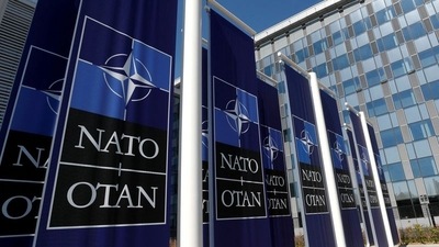 Banners displaying the NATO logo are placed at the entrance of new NATO headquarters during the move to the new building, in Brussels, Belgium. (REUTERS)