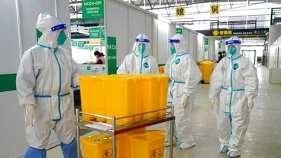 China halves quarantine time for overseas travellers (AP) China halves quarantine time for overseas travellers (AP)