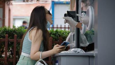 A medical worker takes a swab sample at a nucleic acid testing station, following the coronavirus disease (Covid-19) outbreak, in Beijing. (REUTERS) A medical worker takes a swab sample at a nucleic acid testing station, following the coronavirus disease (Covid-19) outbreak, in Beijing. (REUTERS)