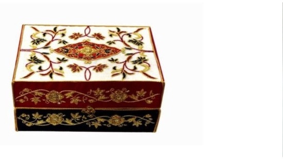 PM Modi gifted Itr bottles in a Zardozi box to French president Emmanuel Macron. The carrier box has been crafted in Lucknow, Uttar Pradesh. The zari zardozi box has been hand embroidered on khadi silk and satin tissue in colours of the French National Flag. The motifs are traditional Indo-Persian, lotus flowers hand-embroidered with metal wire in blue and a pendant used in Kashmiri carpets and motifs from Awadhi architecture. This box includes Attar Mitti, Jasmine oil, Attar Shamama, Attar Gulab, Exotic Musk, and Garam Masala.(ANI)