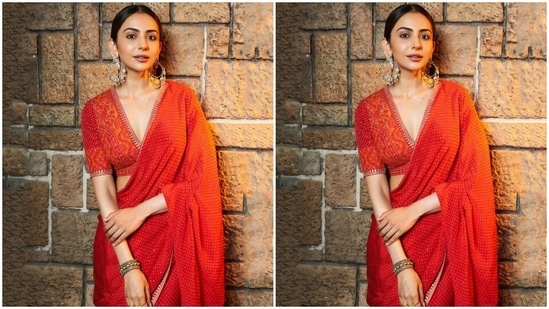 Coming to Rakul Preet's saree, it comes in a bright red shade decked with shimmering dainty sequins, intricate orange patterns and silver gota patti borders. She draped the six yards traditionally, letting the pallu fall from the shoulder elegantly.(Instagram)