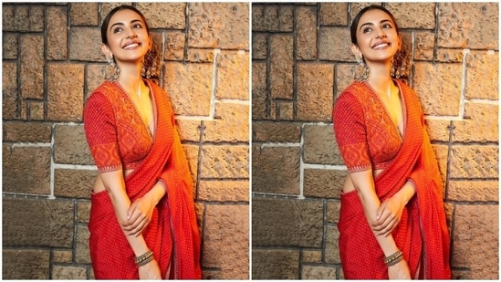 Rakul paired the Bandhani saree with a heavily embroidered blouse. The choli comes in orange and red hues, a plunging V neckline, cropped hem, silver gota patti borders, shimmering silver sequins, Bandhani work, and intricate thread embroidery.(Instagram)