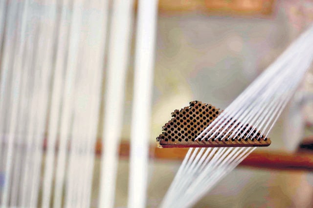 Yarn with a thread count of 350 is passed through a loom’s thread separator. ‘We are still learning to work with such fine yarn. It’s maddening in some ways,’ says researcher Saiful Islam, laughing. (Tapash Paul / Drik-Bengal Muslin) Yarn with a thread count of 350 is passed through a loom’s thread separator. ‘We are still learning to work with such fine yarn. It’s maddening in some ways,’ says researcher Saiful Islam, laughing. (Tapash Paul / Drik-Bengal Muslin)