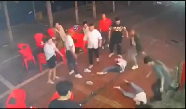 The protesting woman was dragged out of the restaurant — in a way considered most humiliating — by her hair; outside, the kicking and punching continued as she lay on the road crumpled like a piece of cloth.&nbsp; (@badiucao/Twitter)