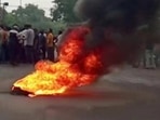 Smoke rises from a burning material while people gather on road as tensions rise after the killing of a tailor, in Udaipur on Tuesday. (Reuters) Smoke rises from a burning material while people gather on road as tensions rise after the killing of a tailor, in Udaipur on Tuesday. (Reuters)