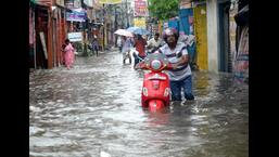 People wade through a waterlogged street in Patna on Wednesday. (Santosh Kumar/HT Photo) People wade through a waterlogged street in Patna on Wednesday. (Santosh Kumar/HT Photo)
