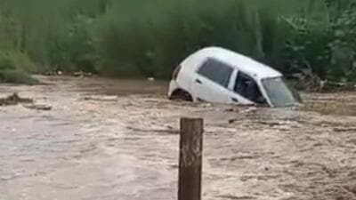 A car being washed away in the overflowing Patiala ki Rao near Dadumajra on Wednesday. (HT PHOTO) A car being washed away in the overflowing Patiala ki Rao near Dadumajra on Wednesday. (HT PHOTO)
