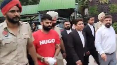 Punjab Police taking gangster Jagdeep Singh, alias Jaggu Bhagwanpuria, to Mansa after getting his transit remand. (HT Photo) Punjab Police taking gangster Jagdeep Singh, alias Jaggu Bhagwanpuria, to Mansa after getting his transit remand. (HT Photo)