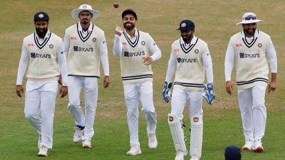 Virat Kohli walks out on the field with with teammates&nbsp; (Reuters)