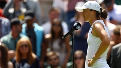 Iga Swiatek speaks to the crowd after winning her first round match against Croatia's Jana Fett (REUTERS)