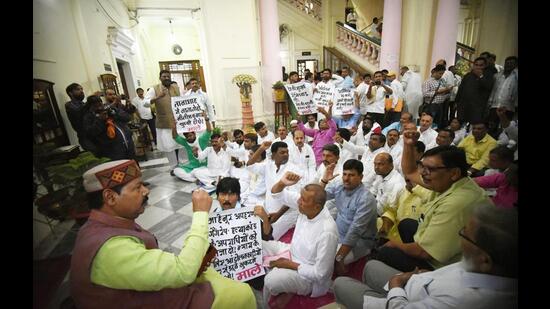 Opposition legislators demonstrate in front of the chamber of Bihar Assembly speaker Vijay Kumar Sinha on Wednesday. (Santosh Kumar/HT Photo)