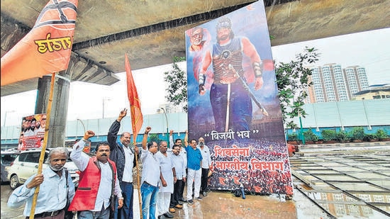 Thane Shiv Sena South Indian Cell members put up a banner in support of Eknath Shinde depicting him as Bahubali outside his house on Wednesday (Praful Gangurde)