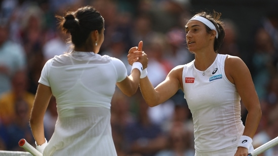 Caroline Garcia shakes hands with Emma Raducanu after winning their second round Wimbledon match.(REUTERS)