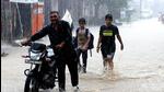 Commuters make their way through a waterlogged road in Rohtak on Thursday. (Manoj Dhaka /Hindustan Times) Commuters make their way through a waterlogged road in Rohtak on Thursday. (Manoj Dhaka /Hindustan Times)