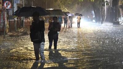 People wade through the waterlogged road near the Andheri subway on Thursday. Vijay Bate/HT Photo People wade through the waterlogged road near the Andheri subway on Thursday. Vijay Bate/HT Photo