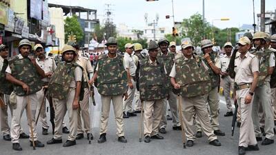 Police stand guard as Hindu groups activists and demonstrators (not pictured) hold a protest rally against the killing of Hindu tailor Kanhaiya Lal, who was allegedly killed by two Muslim men for supporting a former spokeswoman of the ruling BJP for her remarks about the Prophet Mohammed, in Udaipur in Thursday. (AFP) Police stand guard as Hindu groups activists and demonstrators (not pictured) hold a protest rally against the killing of Hindu tailor Kanhaiya Lal, who was allegedly killed by two Muslim men for supporting a former spokeswoman of the ruling BJP for her remarks about the Prophet Mohammed, in Udaipur in Thursday. (AFP)