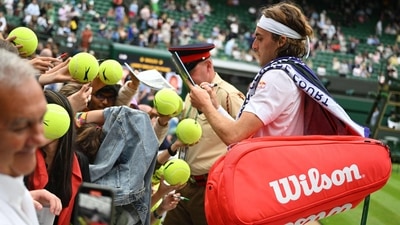 Stefanos Tsitsipas signs autographs after beating Jordan Thompson during their men's singles tennis match at Wimbledon (AFP) Stefanos Tsitsipas signs autographs after beating Jordan Thompson during their men's singles tennis match at Wimbledon (AFP)