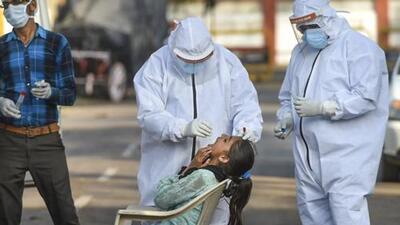 Medics collect a swab sample of a girl for test in Lucknow. (PTI) Medics collect a swab sample of a girl for test in Lucknow. (PTI)