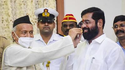 Maharashtra governor Bhagat Singh Koshyari offers sweets to rebel Shiv Sena leader Eknath Shinde. (PTI)