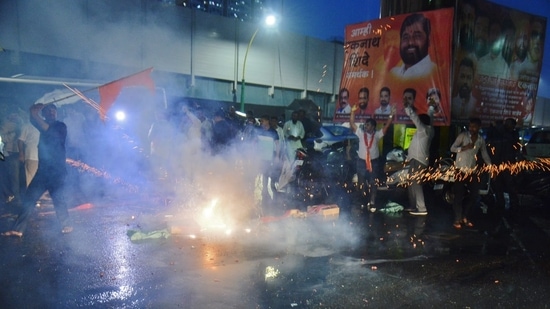 Eknath Shinde's supporters burst firecrackers outside his residence in Thane.(Praful Gangurde / HT Photo)