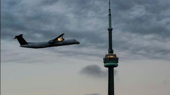 An airplane takes off from Billy Bishop Airport after Canada's Prime Minister Justin Trudeau announced that passengers will require Covid-19 vaccination for air, ship and interprovincial train services, in Toronto, Ontario, Canada. (REUTERS)