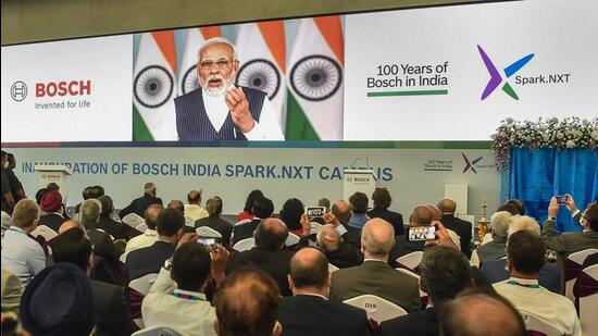 Bosch company officials listen to Prime Minister Narendra Modi as he virtually speaks during the inauguration of the Bosch India's new smart campus in Bengaluru on Thursday. (PTI)