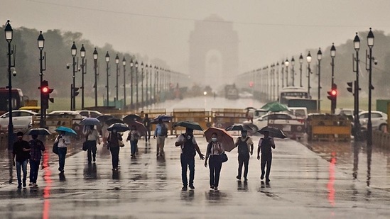 Commuters during heavy rain near India Gate at Rajpath in New Delhi, India, on Thursday, June 30, 2022. (Photo by Raj K Raj/Hindustan Times)