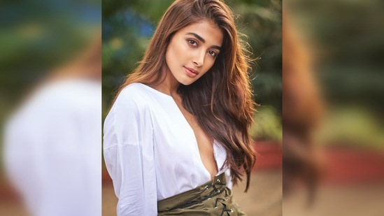 Pooja Hegde earlier set the internet ablaze with her photoshoot pictures in an oversized white shirt featuring a plunging neckline and a short criss-cross front olive green skirt.(Instagram/@hegdepooja)