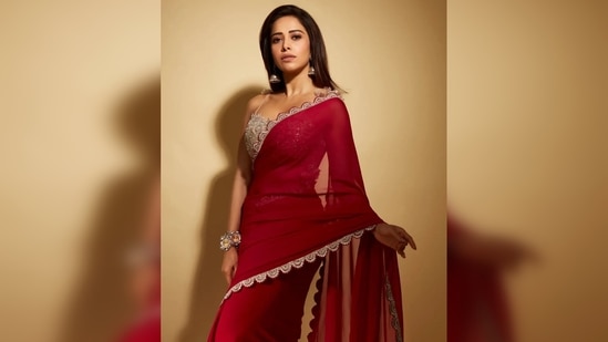 Nusrat Bharuchta captioned his post, "She said I could be anything, so I chose the girl in the red saree."(Instagram / ushnushrattbharuccha)