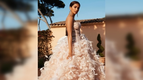 Pooja Hegde also made her Cannes Film Festival debut this year. She graced the red carpet in a shimmery strapless feathered floor-sweeping down.(Instagram/@hegdepooja)