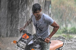 A youth cools himself with rain water during heavy monsoon shower in New Delhi, on &nbsp;June 30, 2022.&nbsp;(PTI)