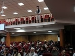 A Taliban fighter stands guard at a news conference about a new command of hijab by Taliban leader Mullah Haibatullah Akhundzada, in Kabul, Afghanistan.