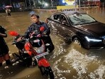 Mumbai, June 30 (ANI): People wade through a waterlogged road as their vehicle gets stuck during heavy rainfall, in Mumbai on Thursday. (ANI Photo)(Deepak Salvi)