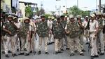 Police stand guard during a protest rally against the tailor’s killing. (AFP) Police stand guard during a protest rally against the tailor’s killing. (AFP)