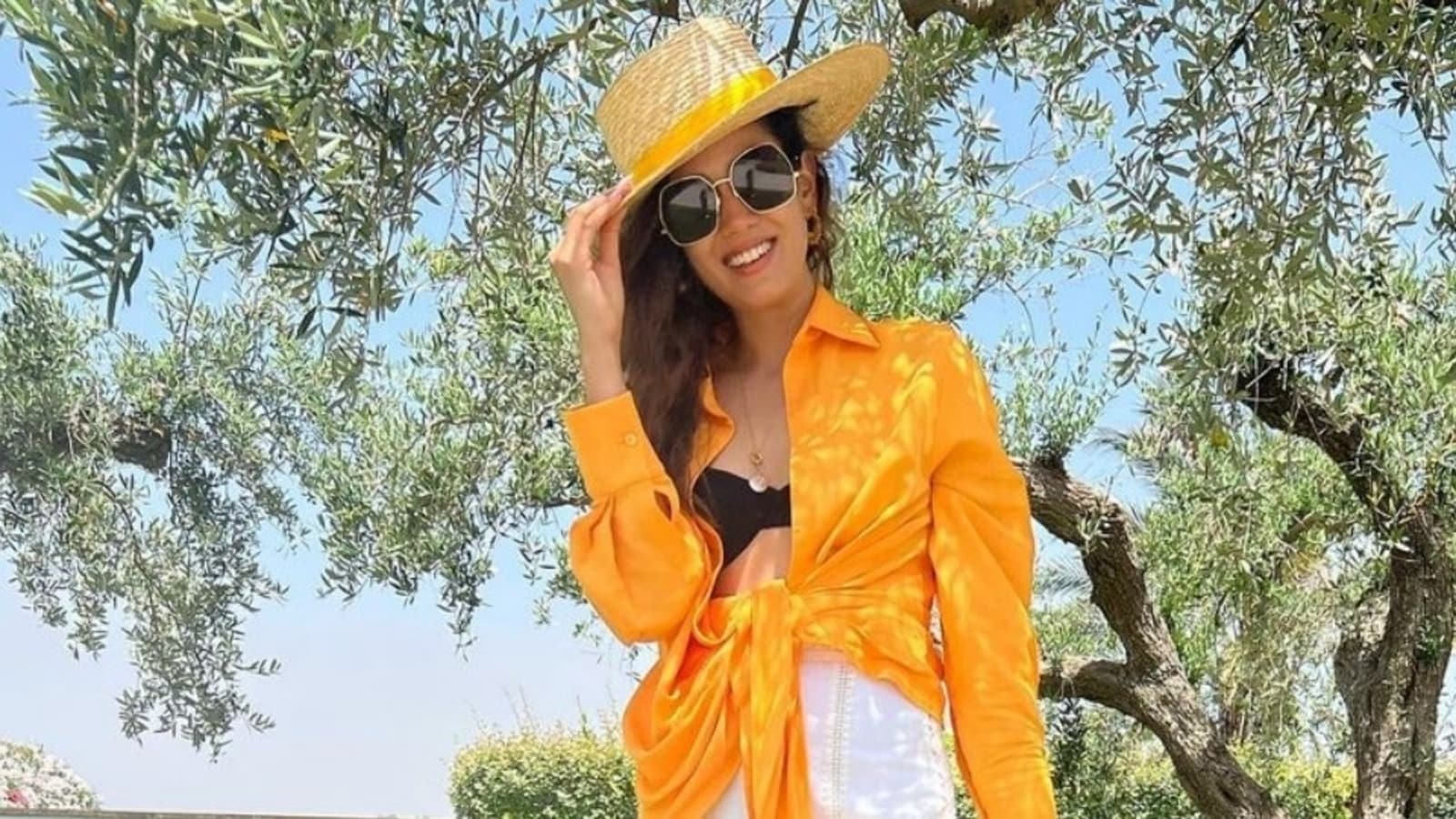 Loved Mira Rajput's orange shirt and white shorts set for Italy