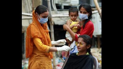 A healthcare worker collects a nasal swab sample of a woman for Covid test in Jammu on Friday. (ANI)