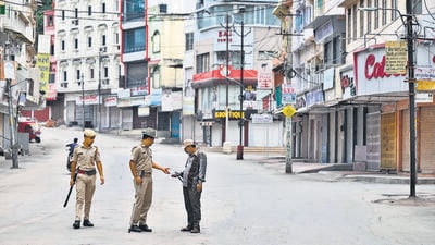 A policeman checks a man’s identity card along a street, amid an ongoing curfew in Udaipur, on Friday. (AFP) A policeman checks a man’s identity card along a street, amid an ongoing curfew in Udaipur, on Friday. (AFP)