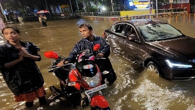 Mumbai, June 30 (ANI): People wade through a waterlogged road as their vehicle gets stuck during heavy rainfall, in Mumbai on Thursday. (ANI Photo) (Deepak Salvi) Mumbai, June 30 (ANI): People wade through a waterlogged road as their vehicle gets stuck during heavy rainfall, in Mumbai on Thursday. (ANI Photo) (Deepak Salvi)
