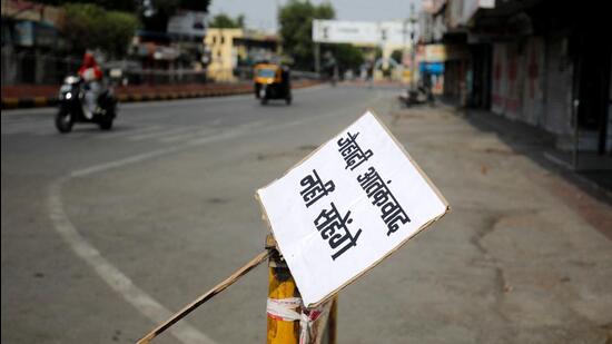 A placard reading "Will not tolerate jehadi terrorism" is tied to a barrier in a deserted road during restrictions imposed by authorities after the death of Kanhaiya Lal, a Hindu tailor killed by two after they videoed themselves slaying him, in Udaipur (REUTERS)