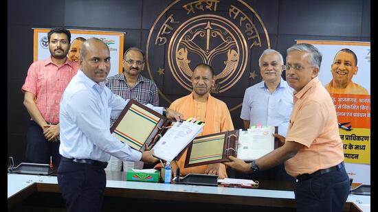 UP government officials exchanging MoU with AAI officials in the presence of CM Yogi Adityanath for 5 new airports, at Lok Bhavan in Lucknow on Friday. (Sourced)
