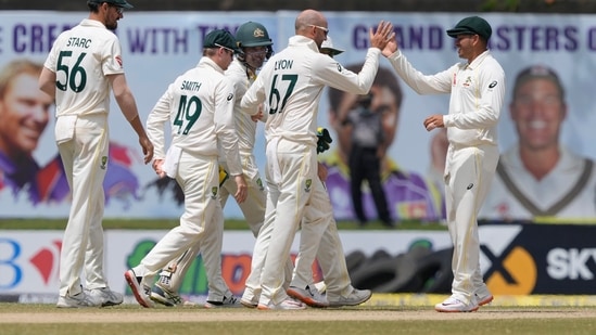 Australia's team members congratulate their bowler Nathan Lyon, second right, for the dismissal of Sri Lanka's Kusal Mendis, right, during the day three of the first test cricket match between Australia and Sri Lanka in Galle.(AP)