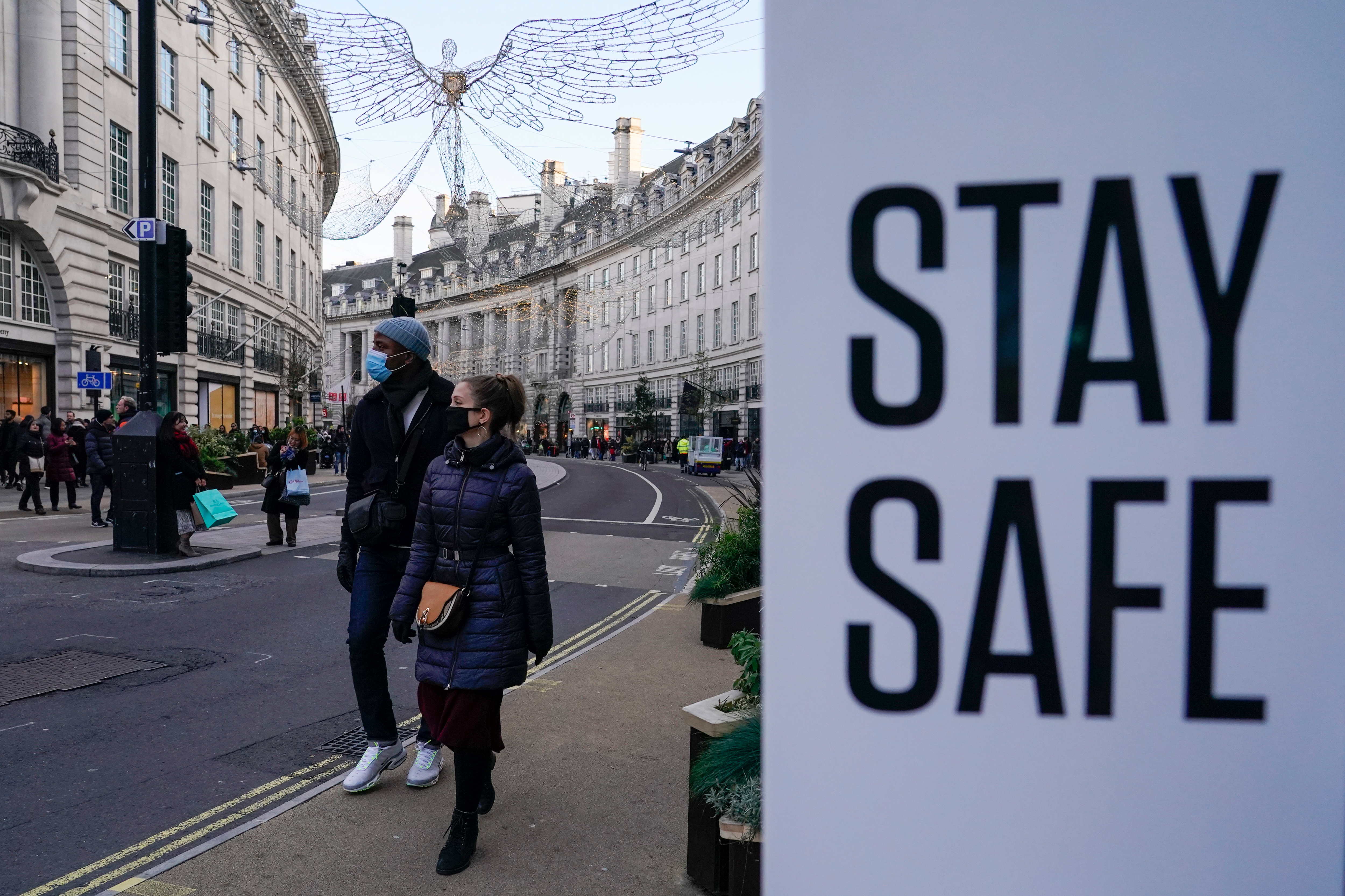 File photo: People wear face masks as they walk, in Regent Street, in London.&nbsp; (AP)