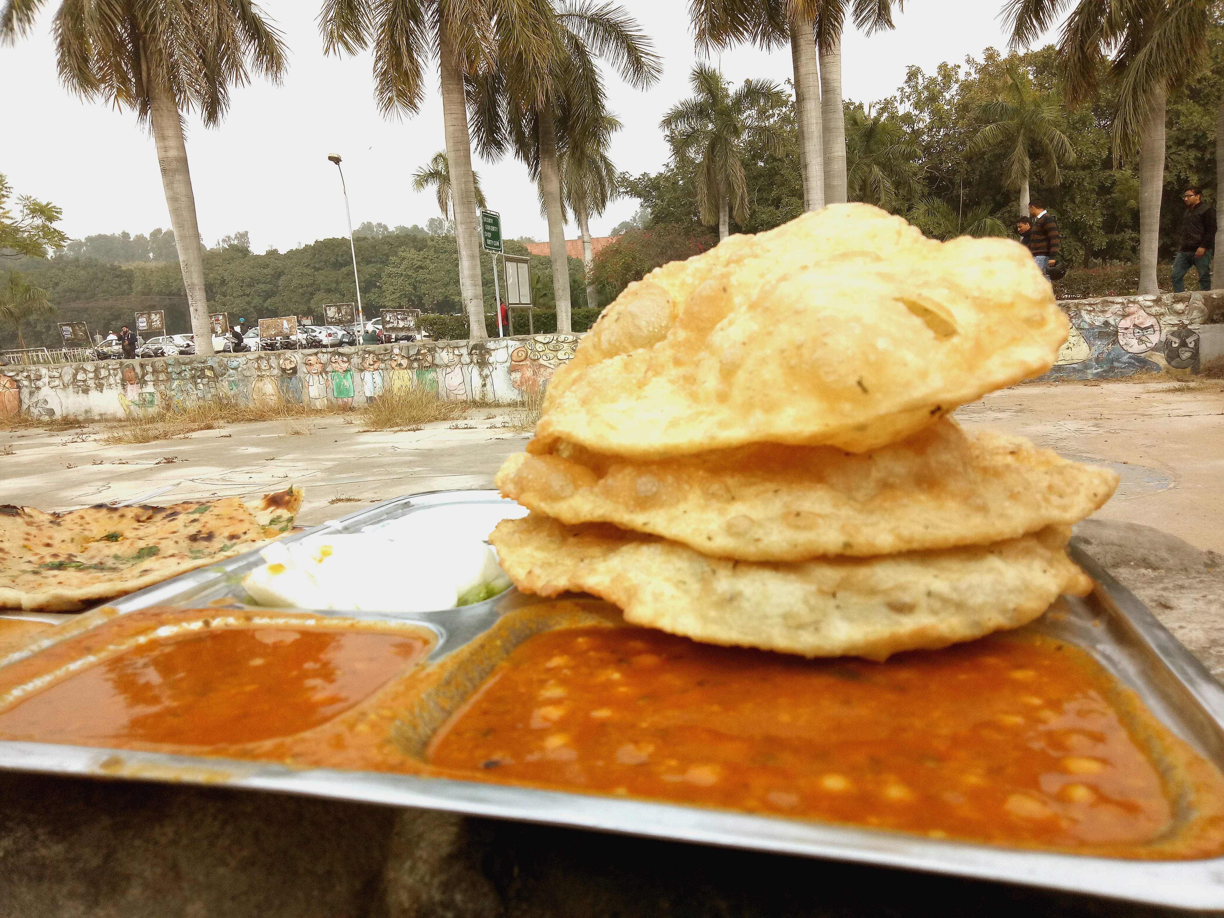 The freshly fried bhaturas feel like mini bites of clouds!